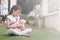 Young little asian girl playing pretend to be a doctor. young girl eaxamine her teddy bear with stethoscope