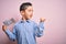 Young little boy kid holding paper sing with help message asking for protection pointing and showing with thumb up to the side