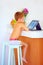 Young little boy watching video through the internet, while sitting in kitchen in the morning