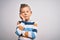 Young little caucasian kid with blue eyes standing wearing striped shirt over isolated background thinking looking tired and bored