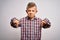 Young little caucasian kid with blue eyes wearing elegant shirt standing over isolated background Pointing down looking sad and