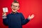 Young little caucasian kid wearing glasses holding paper note with question mark sign very happy and excited, winner expression