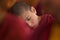 Young little child meditating with closed eyes at the regular puja.