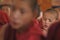 Young little child meditating / dreaming with open eyes at the regular puja from Leh village. Ladakh