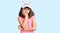 Young little girl with bang wearing funny kitty cap thinking looking tired and bored with depression problems with crossed arms