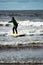 Young little girl on beach taking surfing lessons