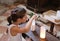 Young little girl lights a candle wax into the Church