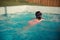Young little girl swimming in hotel