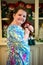 Young little Irish red-headed girl portrait looking and smiling at the camera holding doll that looks like herself