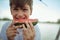 Young little minor boy, eating slice of watermelon