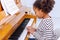 Young little student, practicing piano