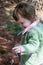 Young little toddler girl with basket searching for easter eggs