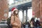 Young local woman in Santa Claus hat walks during a snowfall in New York City on Christmas Eve. Facemask and social distancing -