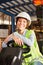 Young logistics woman on the forklift