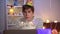 Young lonely Caucasian man blowing out candles on birthday cake. Portrait of depressed millennial guy celebrating alone