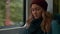 Young lonely Caucasian upset girl in red cap rides in a subway or tram train car, uses the phone, prints a message. Slow