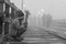 Young lonely poor boy selling flowers at Mon wooden bridge in cold morning