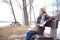 Young lonely woman on bench in park