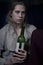 Young lonely woman with wine