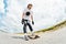 The young Longboarder pushes his foot out on his longboard over the country road