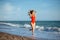 Young longhaired girl in red swimsuit