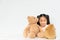 Young lovely Asian girl playing with 2 cute teddybear dolls at home, copy space on white wall background