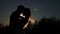 Young lovely couple hugging silhouette