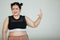 Young and lovely cute Asian fat woman in sport wear pose to camera with a happy and positive gesture with self-confidence. She