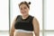 Young and lovely cute Asian fat woman in sport wear pose to camera with a happy and positive gesture with self-confidence and self