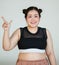 Young and lovely cute Asian fat woman in sport wear pose to camera with a happy and positive gesture with self-confidence and self