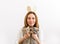 Young lovely and positive women wearing bunny ears and having fun with two cats. Minimalist look on the white background. Easter