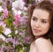 Young lovely woman in spring flowers