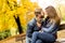 Young loving couple on a bench in autumn park