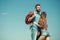 Young loving couple embracing at cloudless blue sky background. Bearded man and beautiful woman with curly hair