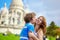 Young loving couple kissing near the Sacre-Coeur