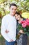 Young loving couple in love, girl holding flowers, happy and enjoy the beautiful nature, advertising, and utsava text