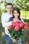 Young loving couple in love, girl holding flowers, happy and enjoy the beautiful nature, advertising, and utsava text
