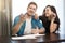 Young loving couple man and woman looking excited, sitting together, studying layout of their new apartment ,happy wife