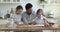 Young loving father teach children to prepare homemade dough