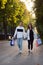 Young loving man and woman is walking in park. Shopping bags in hands. Vertical frame