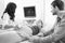 Young loving pregnant couple visiting doctor together monochrome