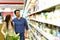 Young lucky couple shopping for fresh food in the supermarket -