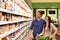 Young lucky couple shopping for fresh food in the supermarket -