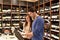 Young lucky couple shopping for wine in the supermarket