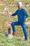 Young lumberjack with beard holds his ax in his hand