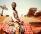 A young Maasai African boy from Kenya on a horseback