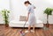 Young maid cleaning floor