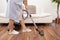 Young maid cleaning floor