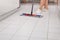 Young Maid Cleaning Kitchen Floor