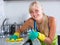 Young maid dusting kitchen tops